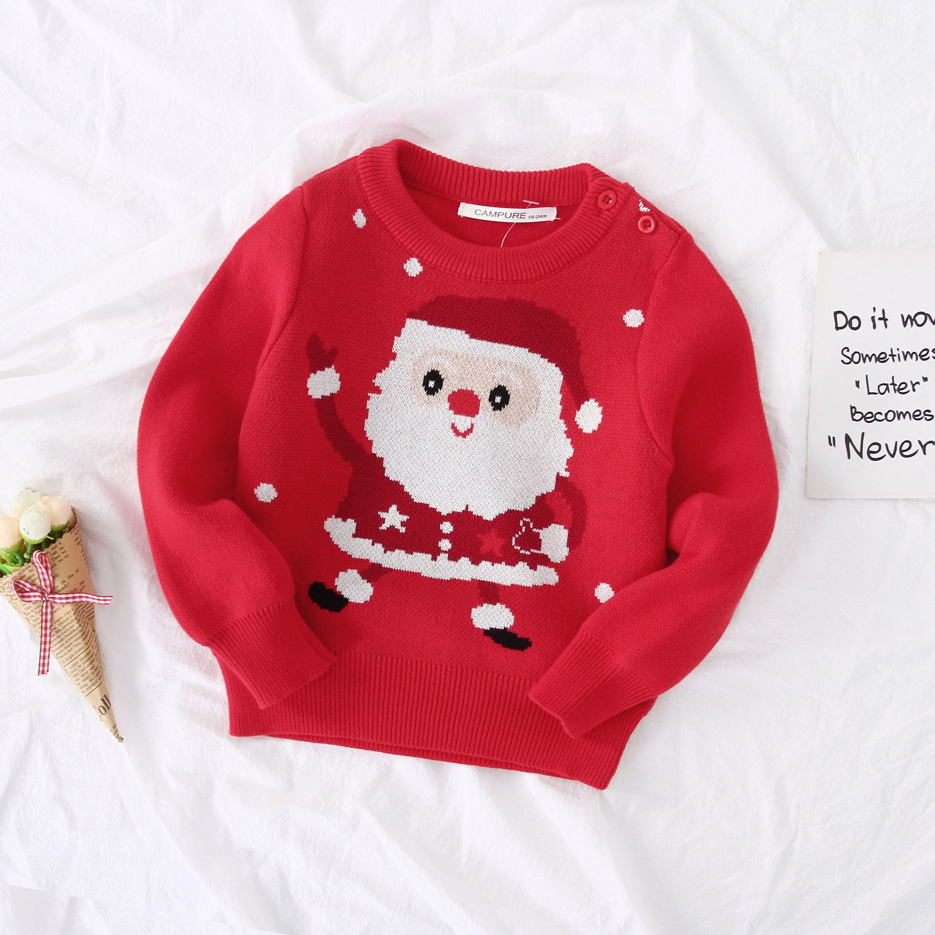 Red sweater with Santa Claus design on a white background